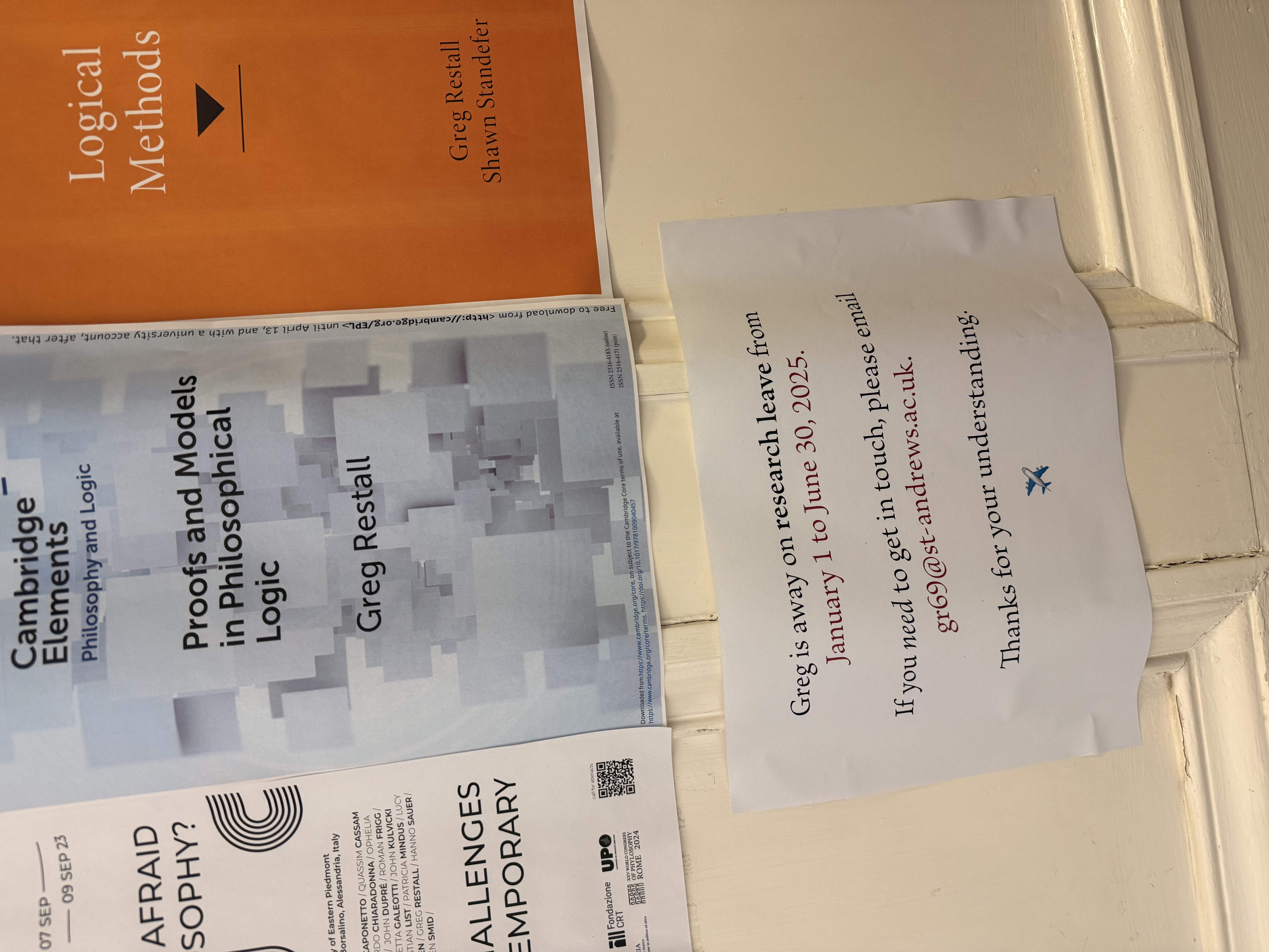 A printed
notice -- stating that the office holder is away on research leave- -- on a
wooden door